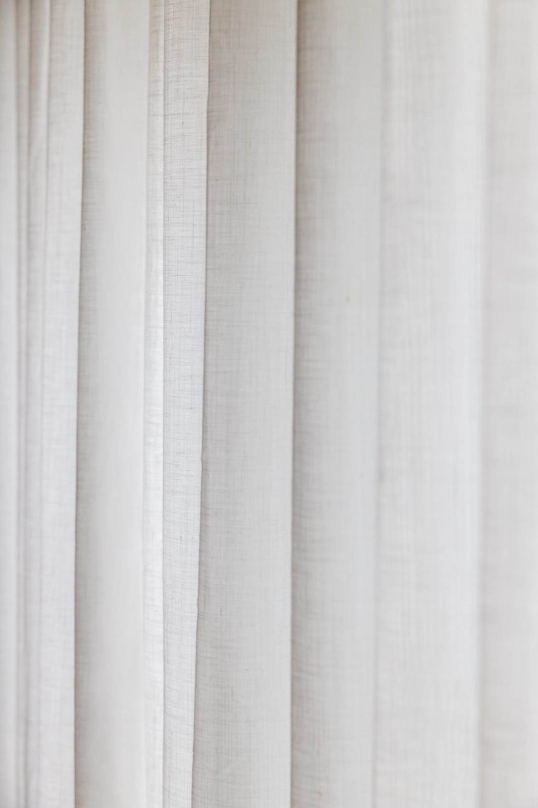Sheer curtains layered across a bright living room