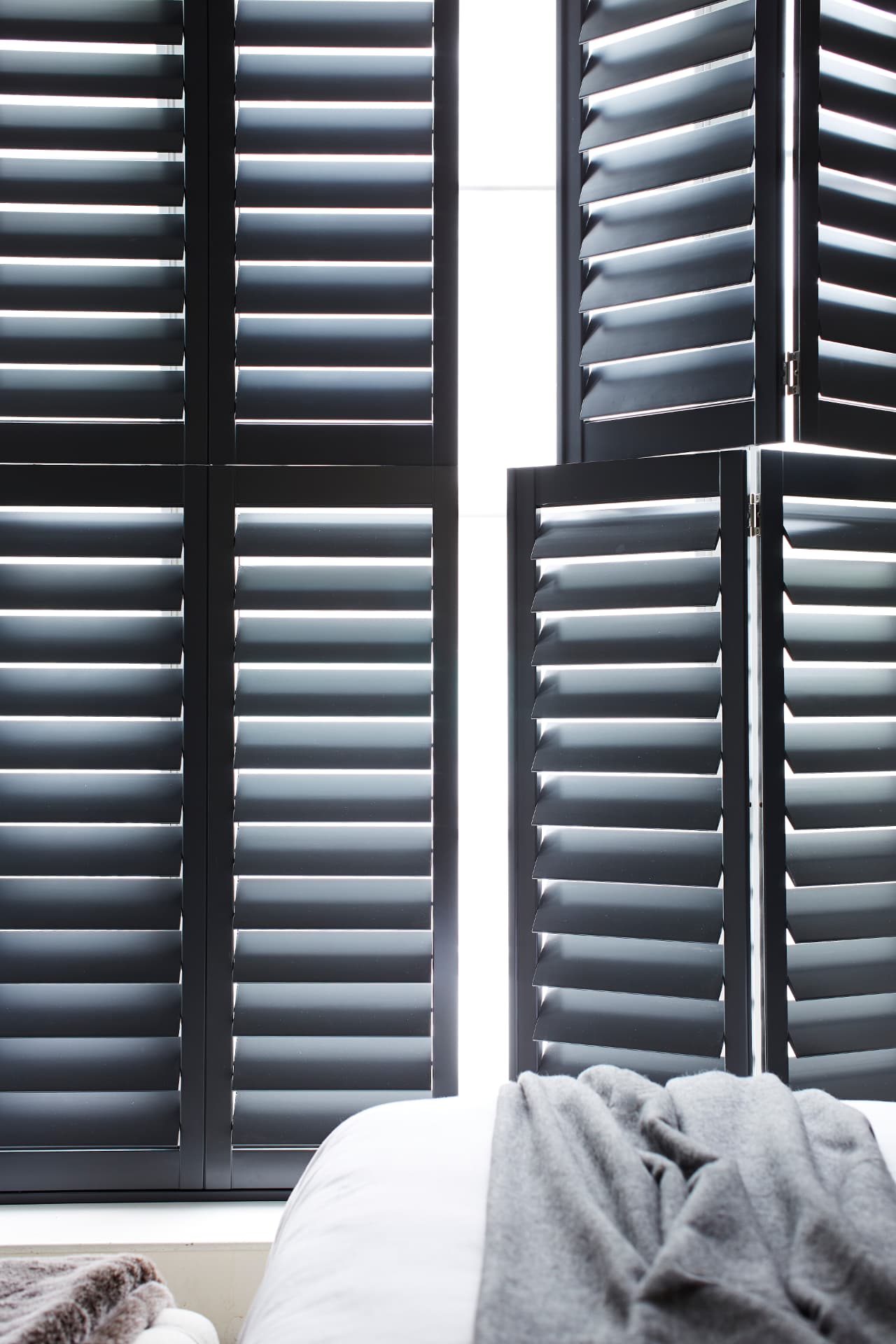 Black tier-on-tier shutters with the top tier folded open