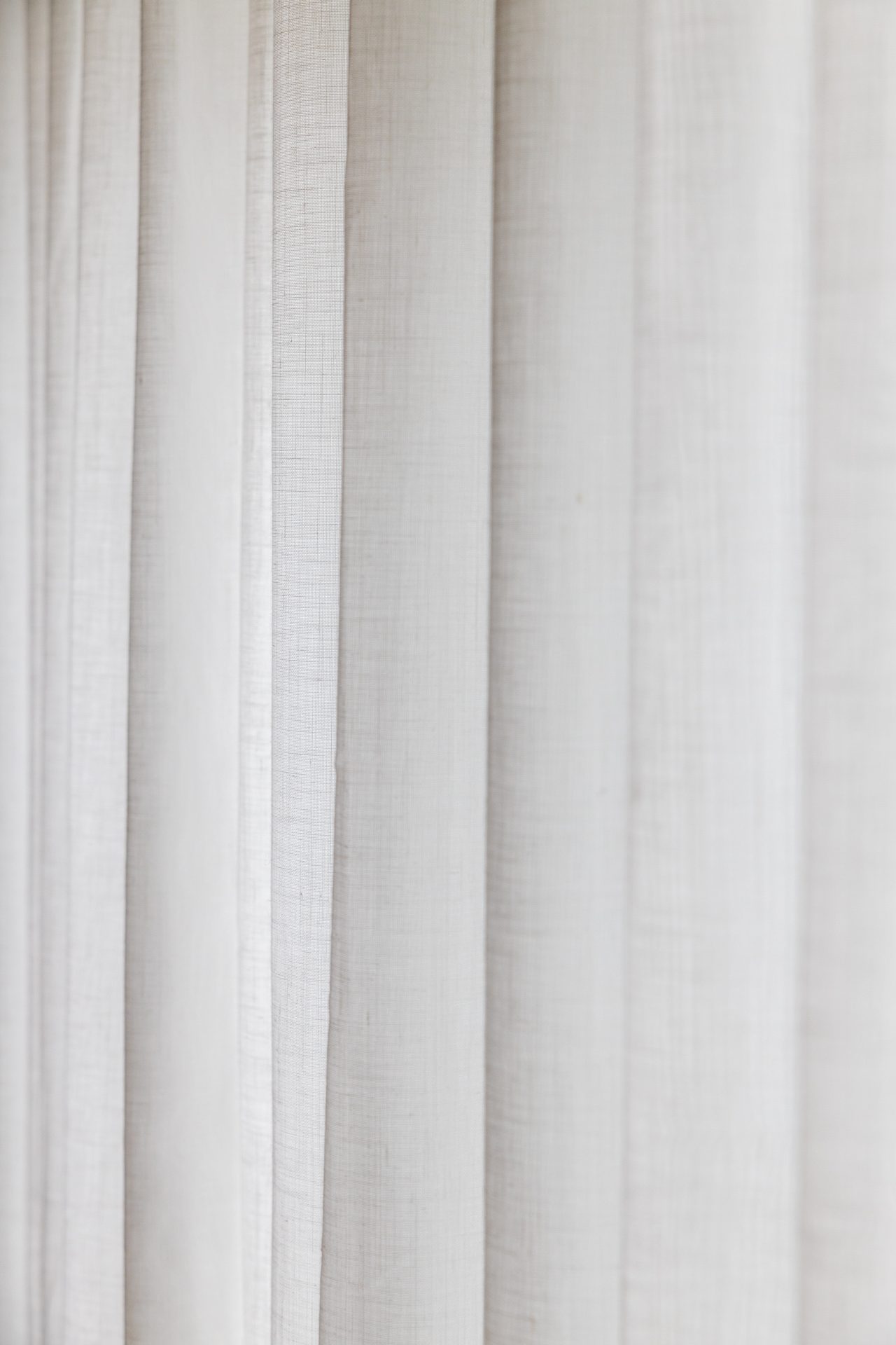 Sheer curtains layered across a bright living room