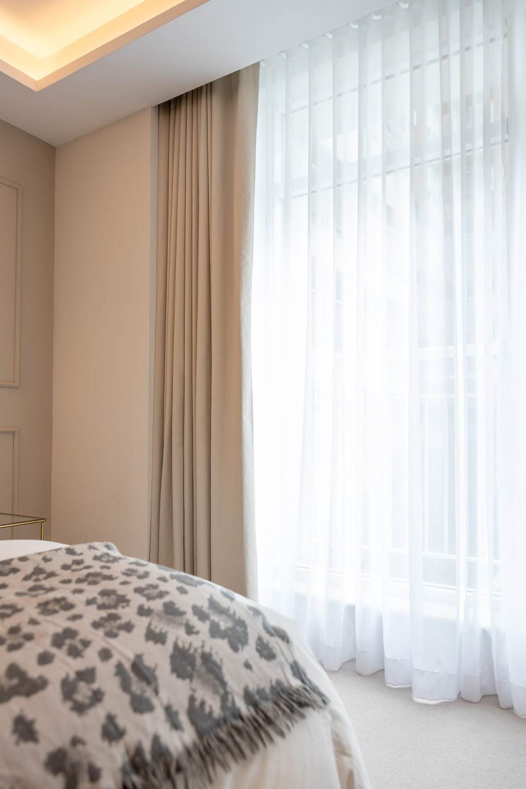 Full-length curtains framing a bedroom window