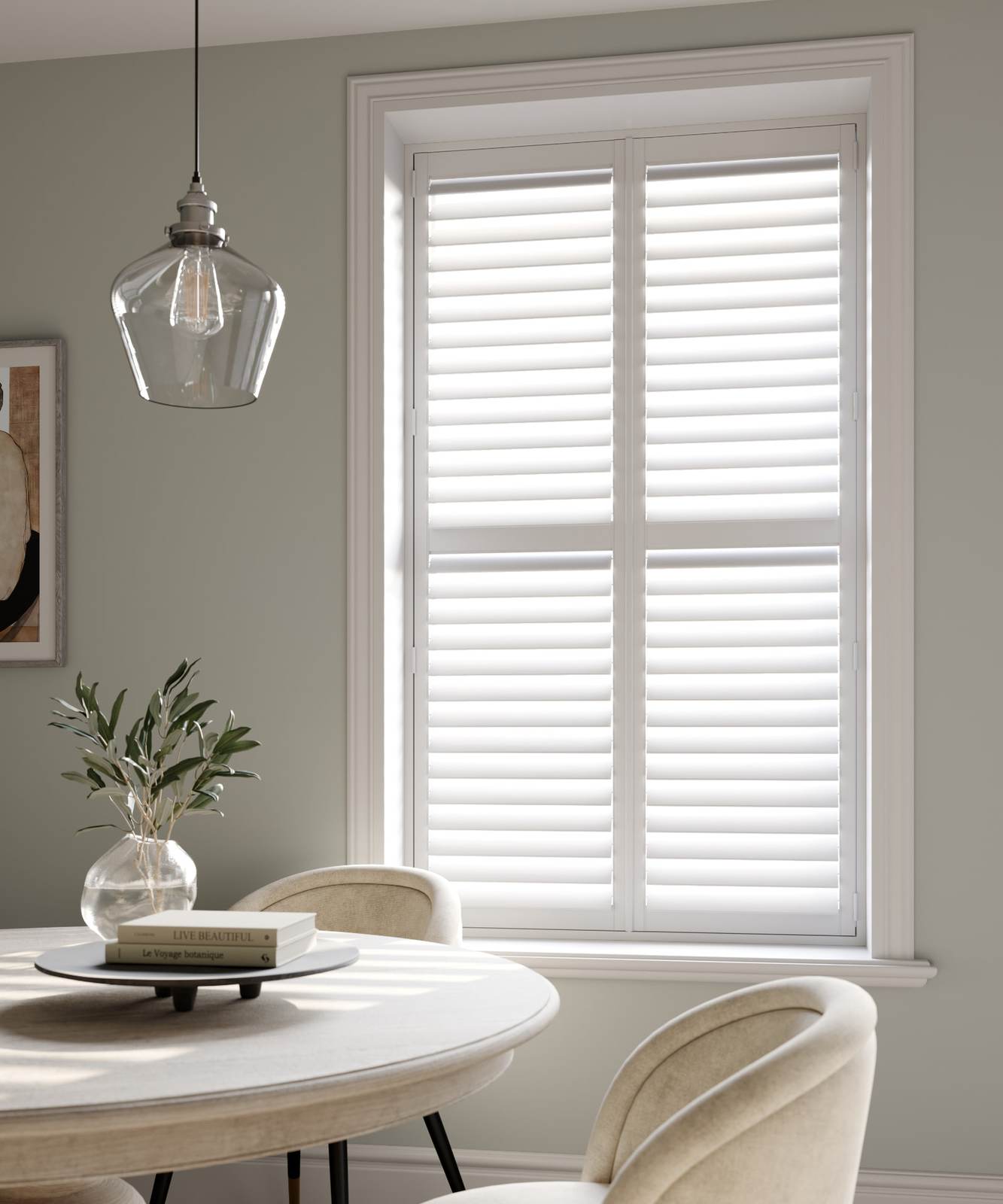 White full height shutters with a mid-rail in a soft green dining room