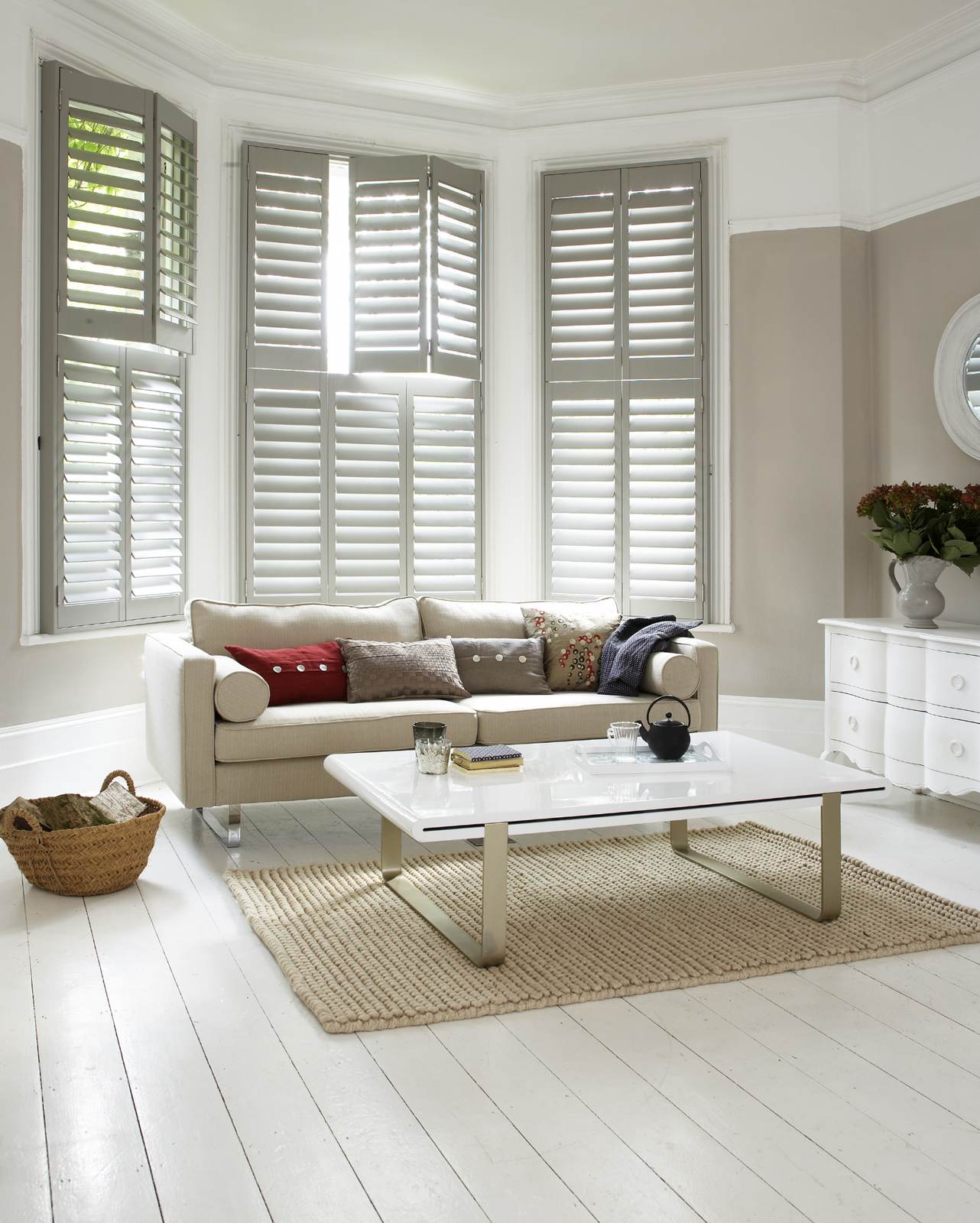 Tier-on-tier shutters in a taupe and white sitting room bay