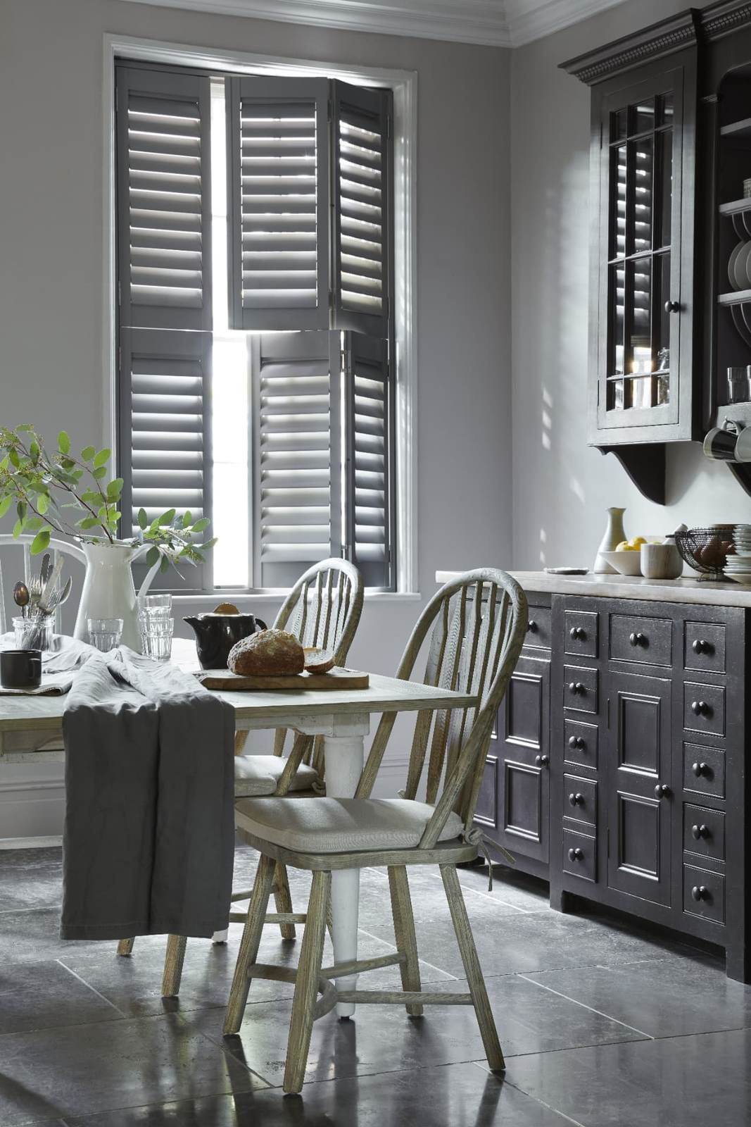 Tier-on-tier shutters with the top tier open above a kitchen table