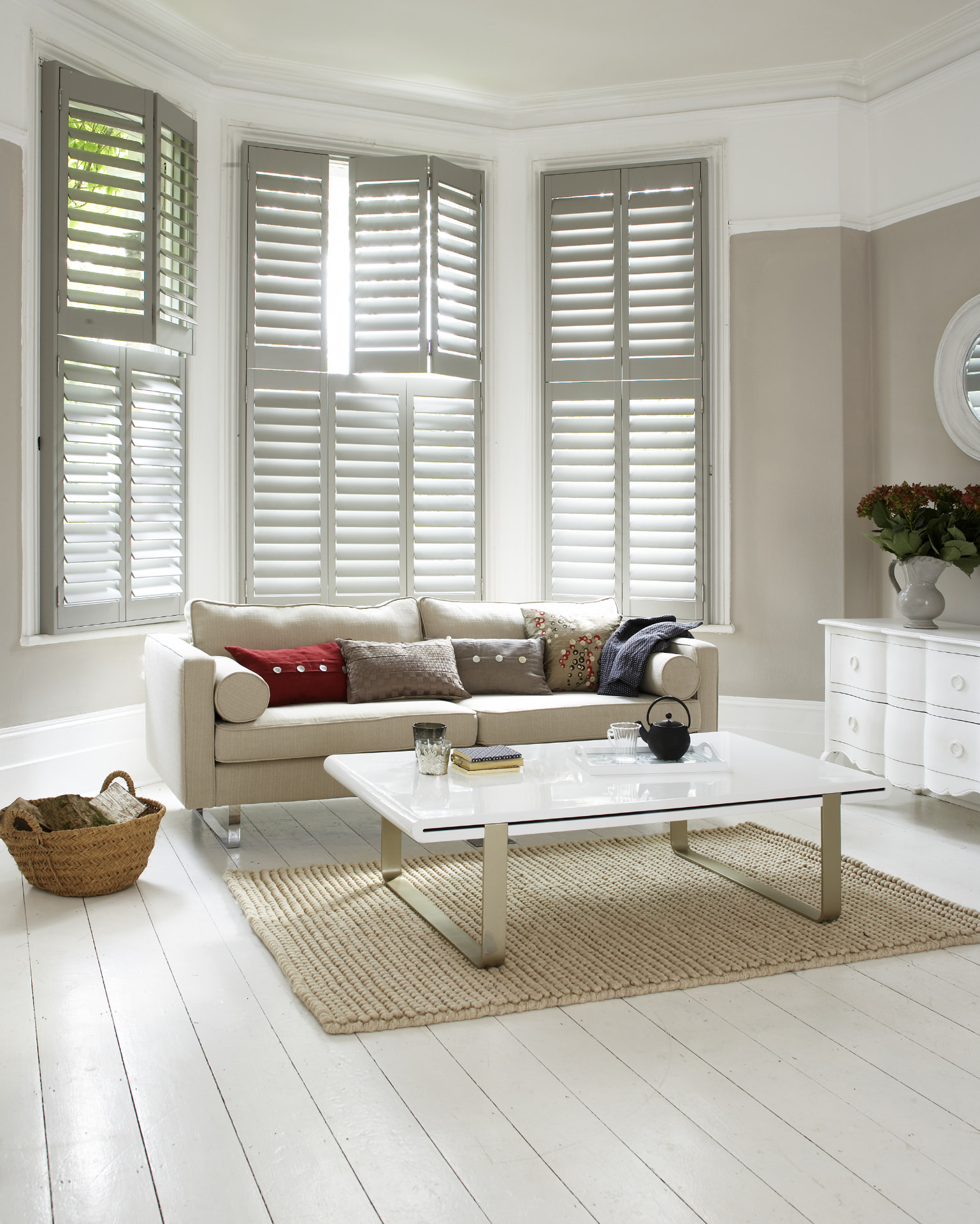 Tier-on-tier shutters in a taupe and white sitting room bay