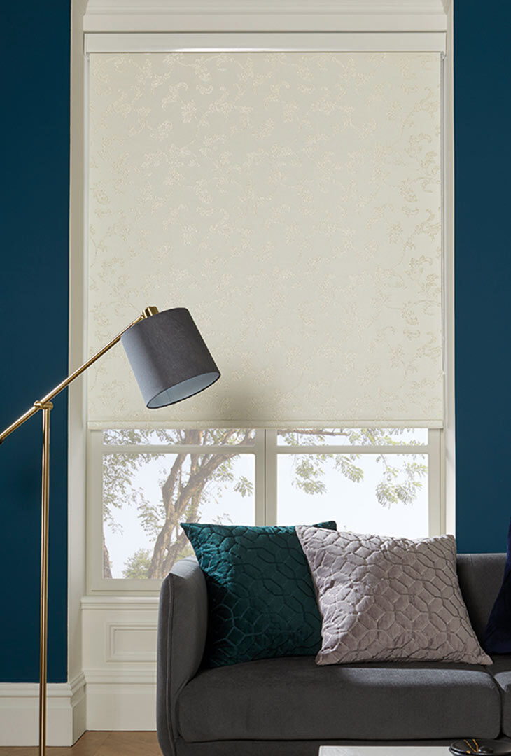 Patterned roller blind against a deep blue living room wall