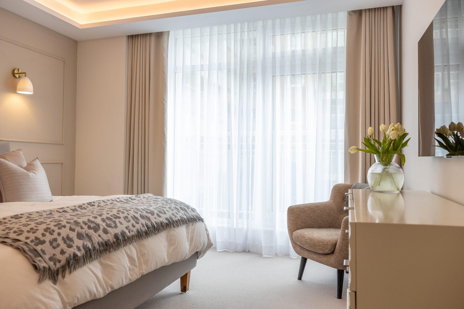 Bedroom curtains with bedside lamps and soft textiles