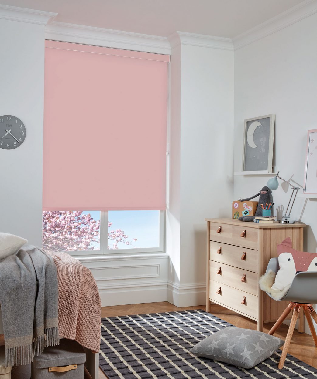 Blush pink blackout roller blind in a child's bedroom