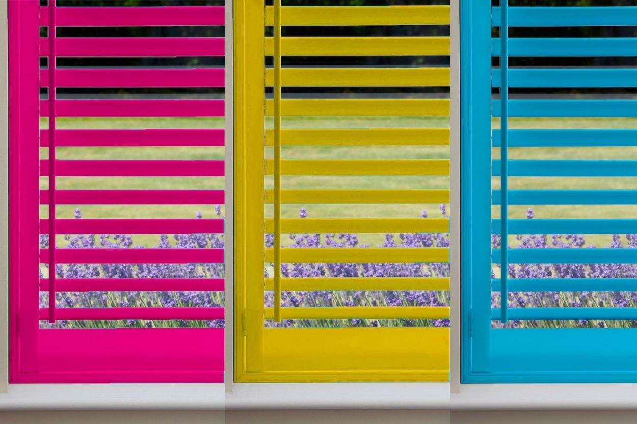 Shutters painted in bright pink, yellow and blue custom colours