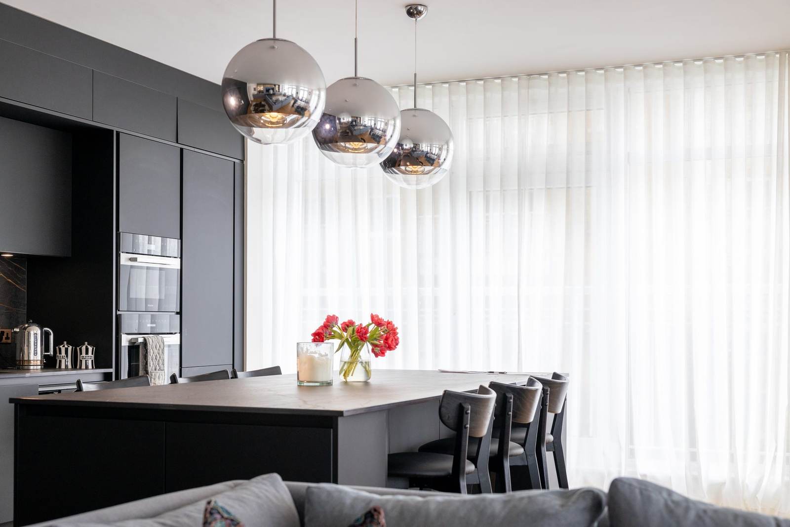 Full length curtains framing a window in a softly lit room