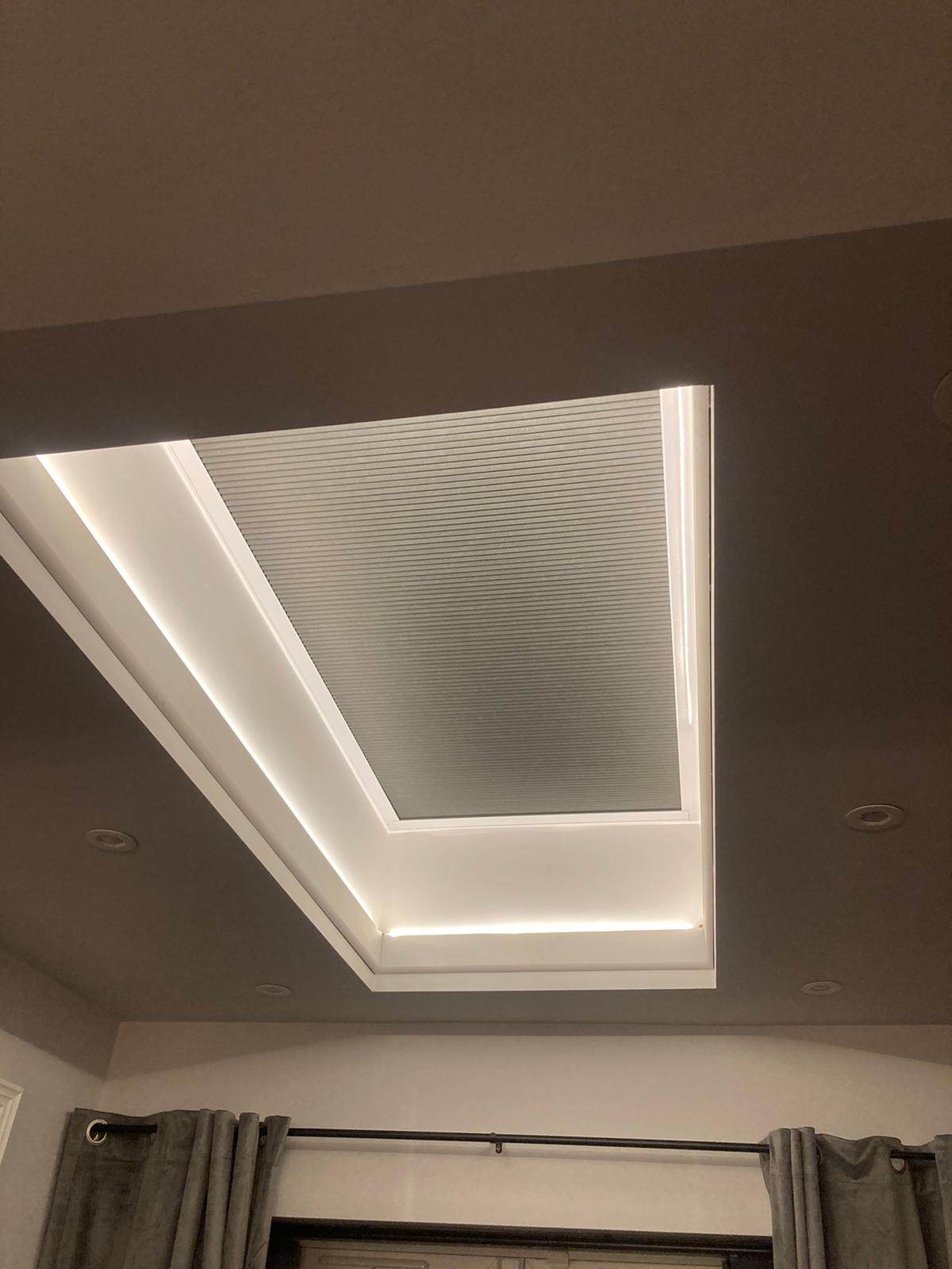 Skylight blind closed in the evening in a bedroom
