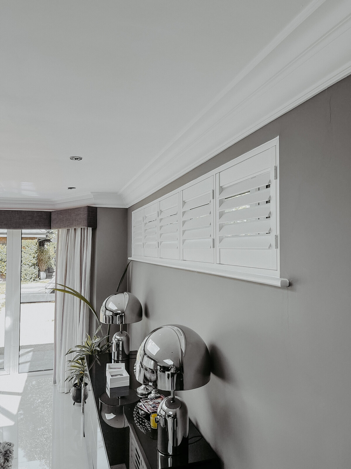Café style shutters in a grey painted hallway