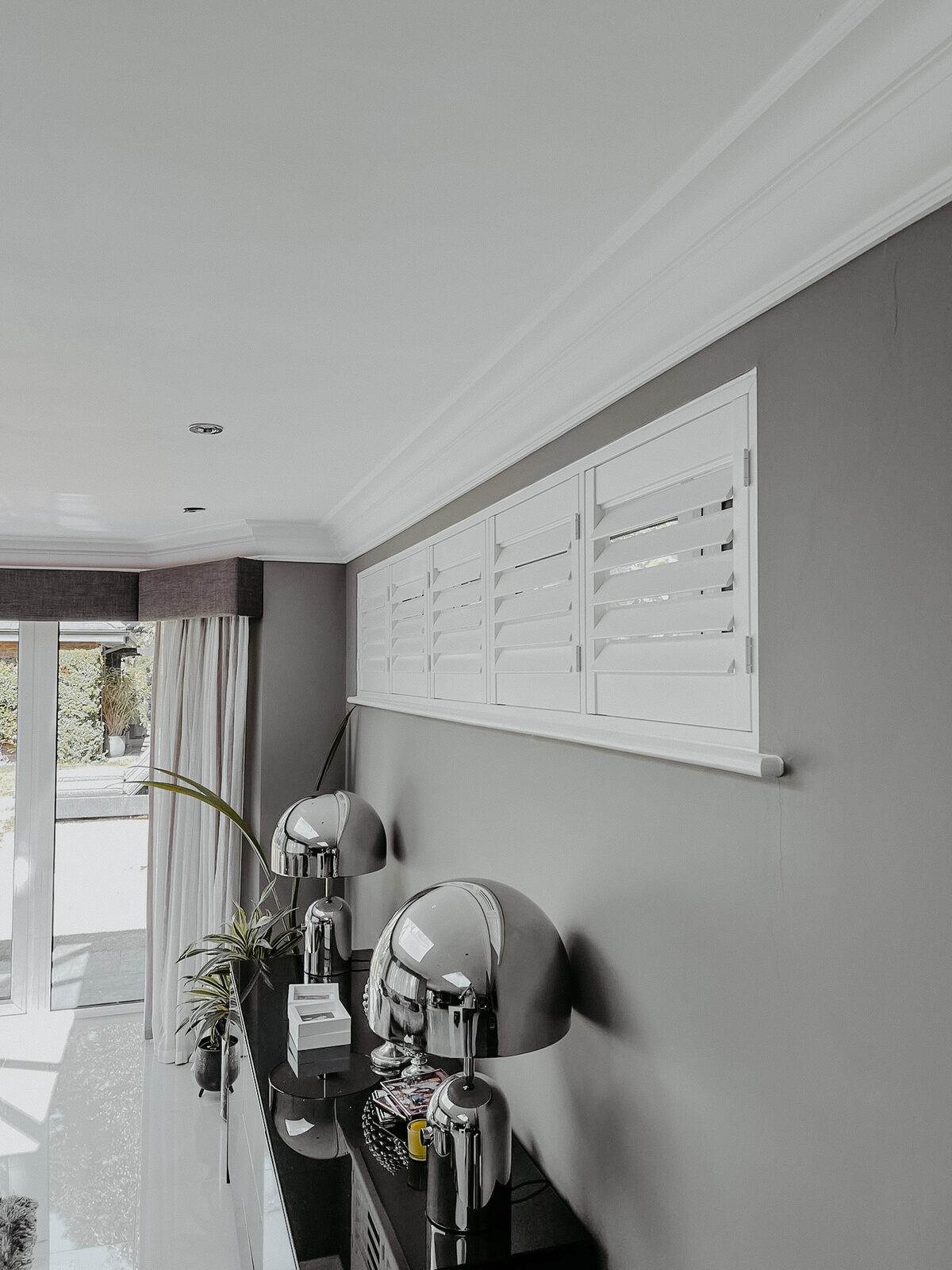 Café style shutters in a grey painted hallway